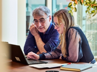 Man and woman looking at a laptop
