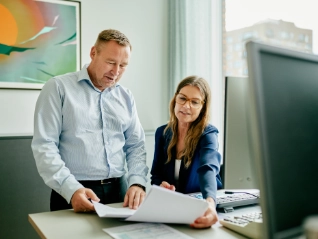 Colleagues discussing report