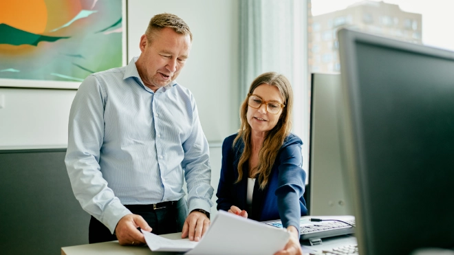 Colleagues discussing report