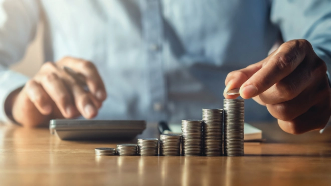 saving money with hand putting coins on stack concept financial