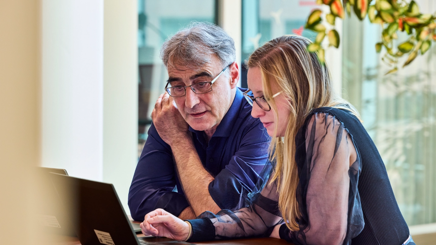 Man and woman looking at a laptop