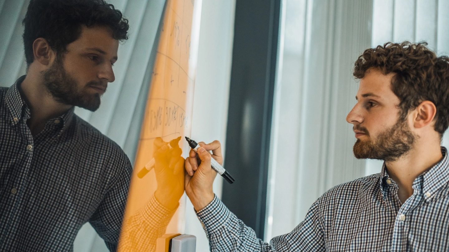 Atradius Colleague working on a board in the Paris Office image