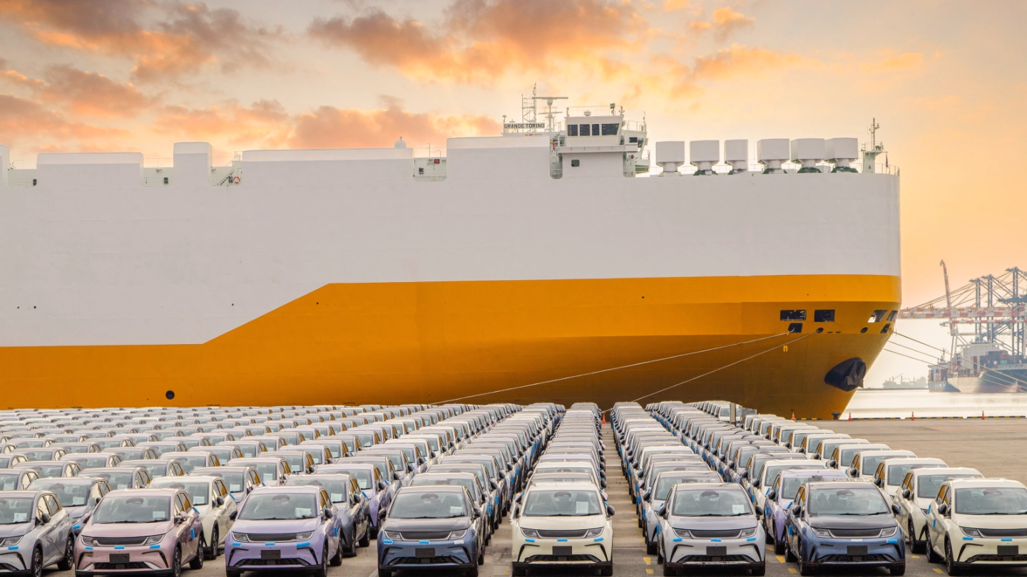 new cars parked in front of a ship in the harbour new cars parked in front of a ship in the harbour